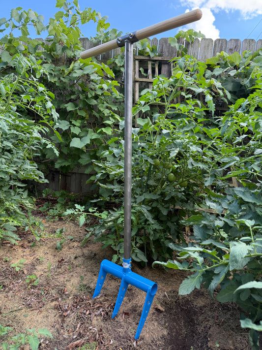Gardening tool hand tiller in the garden