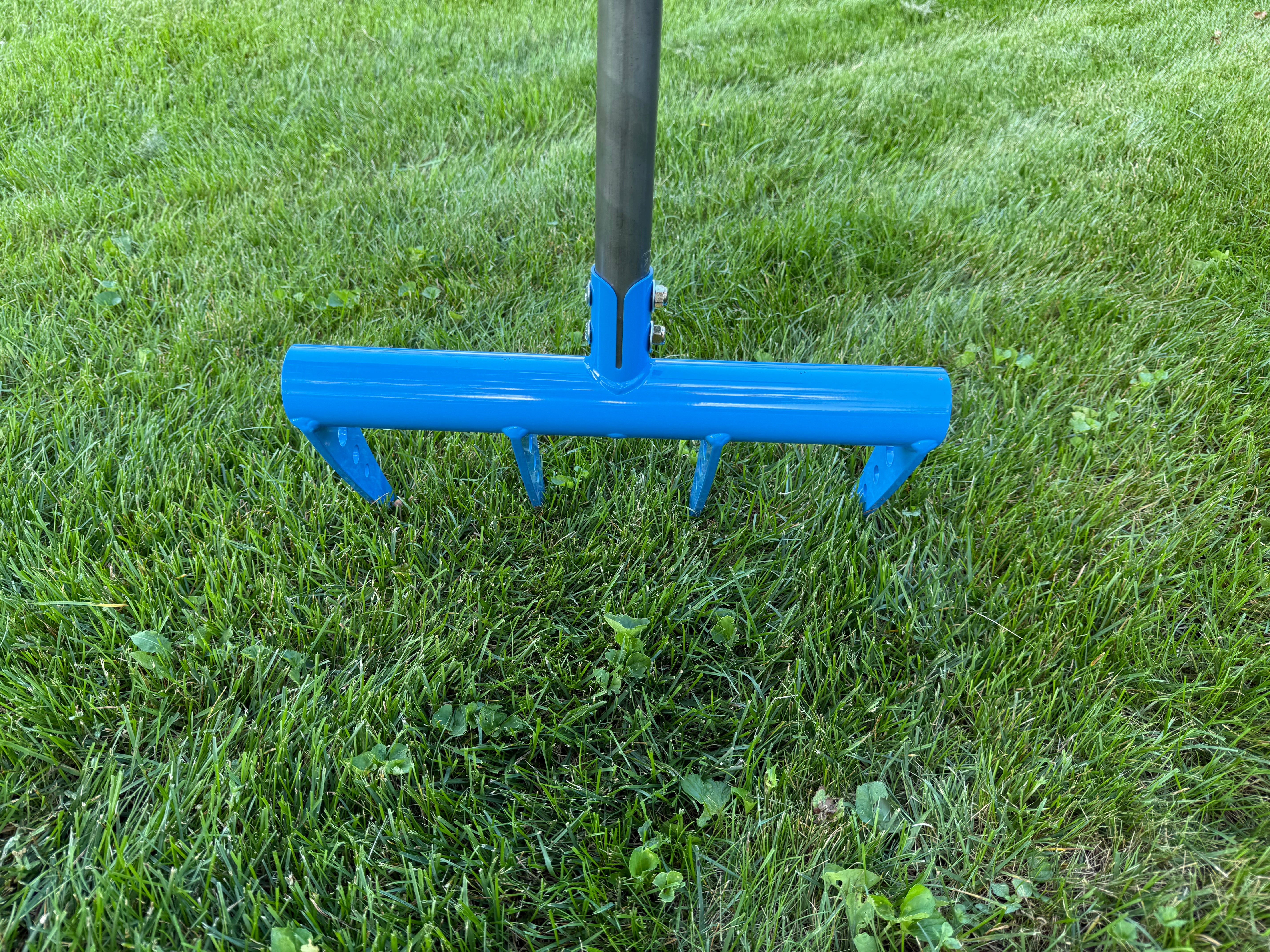 Blue broadfork garden tool closeup 